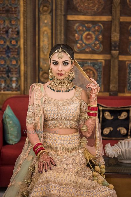 Photo of Beige lehenga with cold shoulder blouse