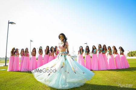 Photo of Matching bridesmaids and twirling bride