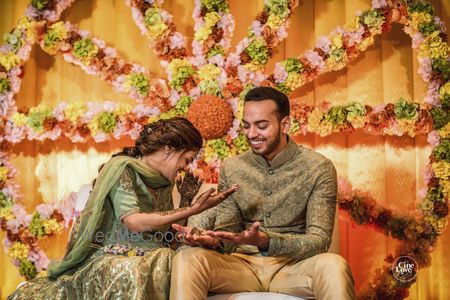 Photo of Cute couple mehendi portrait with backdrop