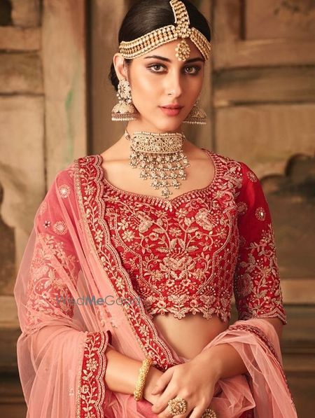 Photo of Pretty red bridal lehenga with unique choker necklace