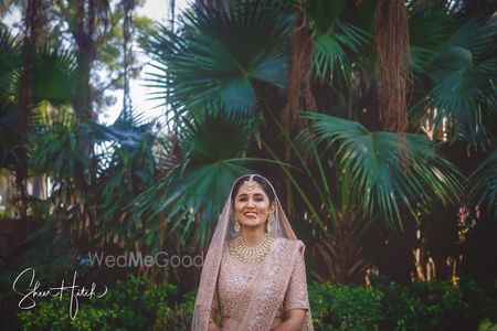 Photo of Outdoor bridal shoot in pink lehenga