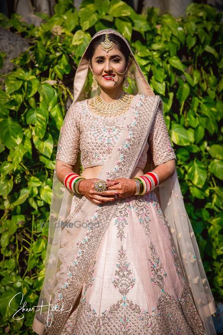 Photo of Blush pink bridal lehenga with blue work