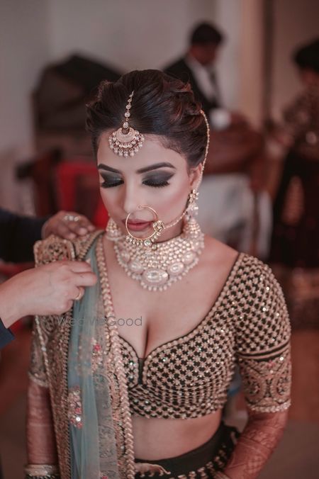 Photo of Bridal makeup with smokey eyes and sabya lehenga