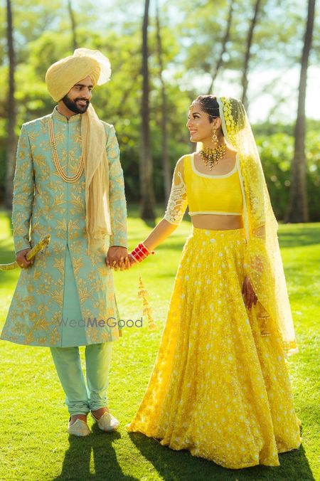 Photo of Yellow bridal lehenga and turqyiuse sherwani