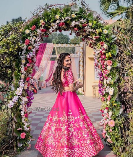 Photo of A bride in a pink lehenga on her mehendi