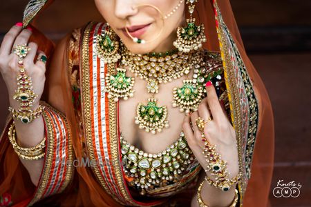 Photo of Layered polki and enamel necklaces in green for bridal look