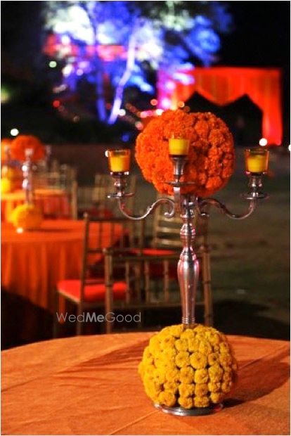 Photo of Silver Candelabras with Genda Phool Table Decor