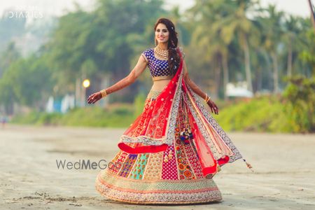 Photo of Twirling bride in multicolored lehenga