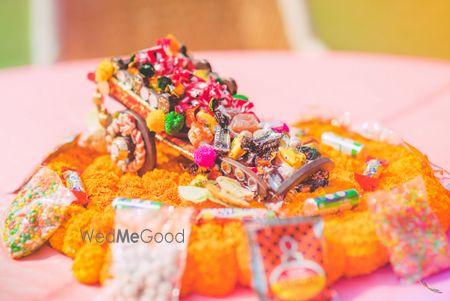 Photo of Floral Wheel Barrow with Candies