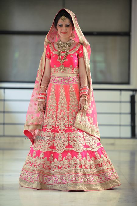 Photo of Fuchsia Pink and Peach Shaded Lehenga with Zari Work