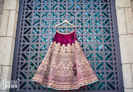 Photo of velvet bridal lehenga on hanger shot