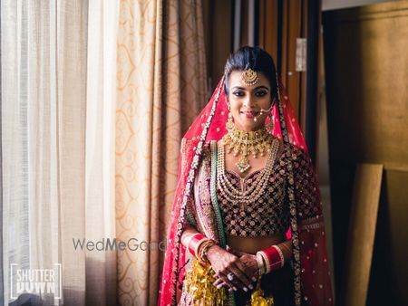 Photo of maroon lehenga with contrasting border dupatta