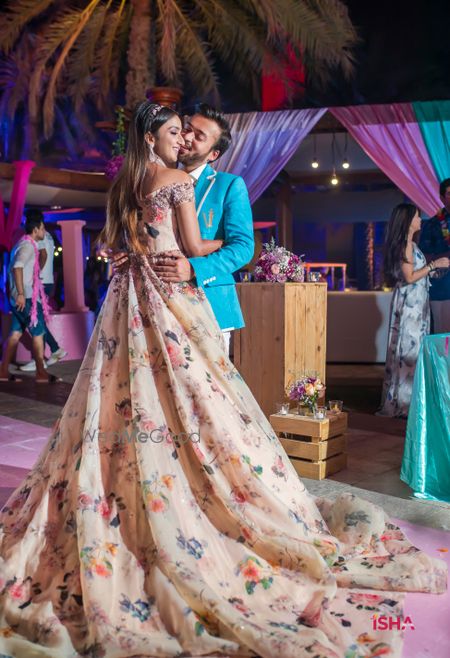 Photo of bride in floral cocktail gown with train