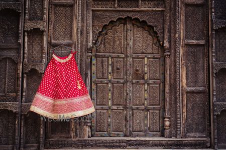 Photo of Red Bridal Lehenga with Border on a Hanger