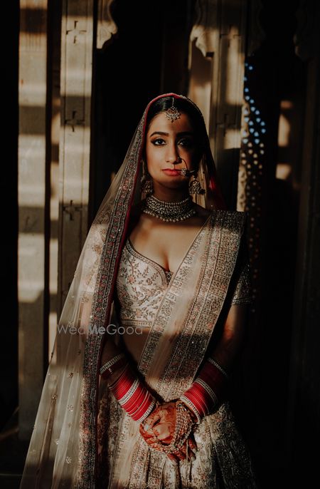 Photo of editorial style bridal shoot in ivory lehenga