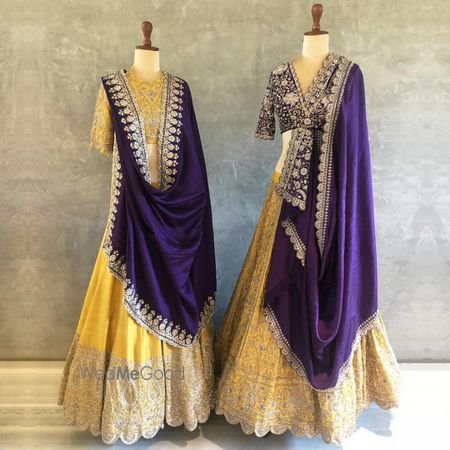 Photo of Vibrant yellow lehenga with contrasting purple dupatta.