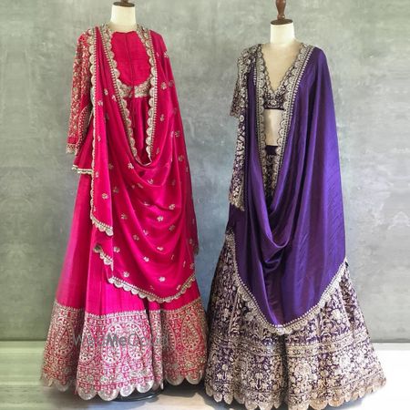 Photo of Vibrant pink anarkali with detailing and purple lehenga with silver work.