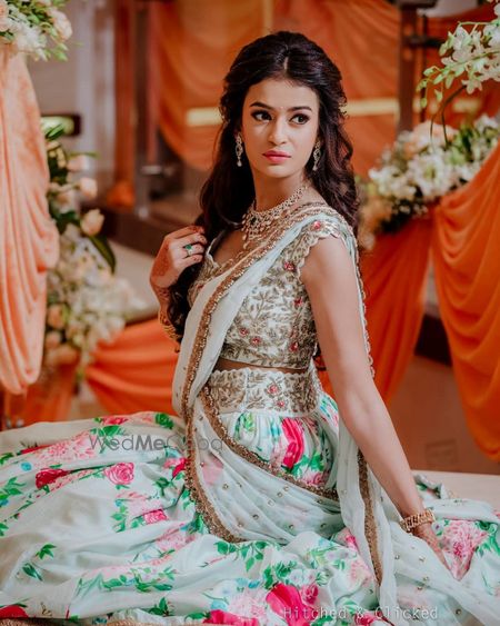 Photo of Bride dressed in a floral printed lehenga and an embroidered blouse