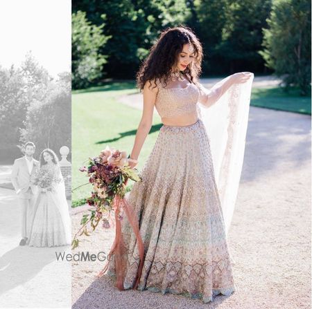 Photo of A beautiful bridal shot in a pastel lehenga .