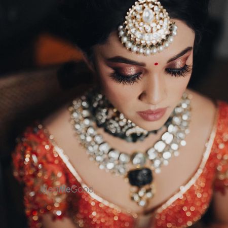 Photo of A wedding day bridal makeup look with shimmer rose gold eyes