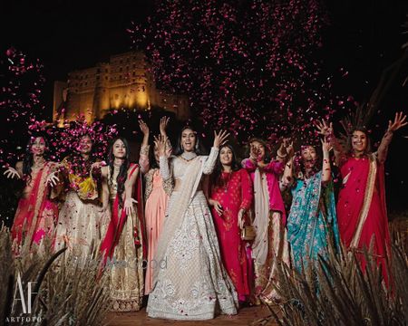 Photo of Bride with bridesmaids in a fun shot