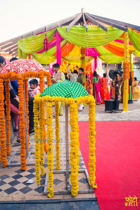 Photo of Orange and Yellow Genda Phool  Umbrella Mehendi Decor