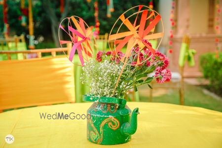 Photo of Tea Kettle centrepiece filled with flowers and pinwheels.