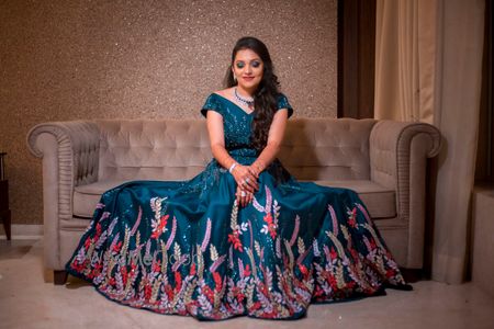 Photo of Beautiful teal gown with colourful floral detailing