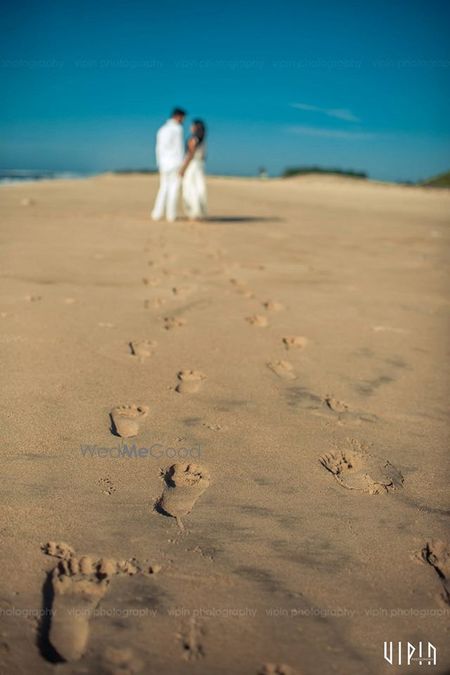 Photo of Beach Wedding Couple Portrait with Sand Footprints