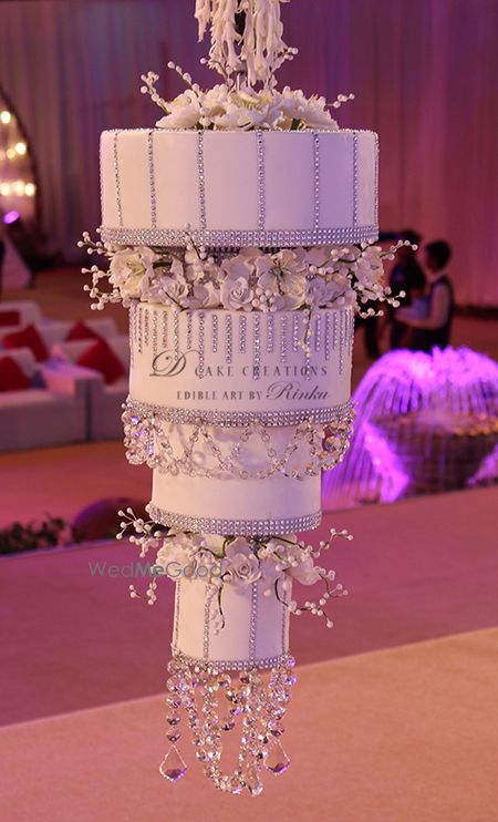 Photo of unique upside down cake with crystals and feathers