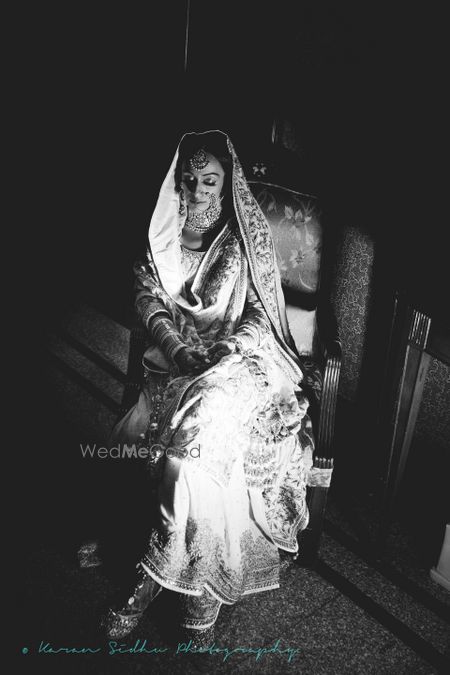 Photo of Black and White Timeless Sitting Sikh Bride Portrait