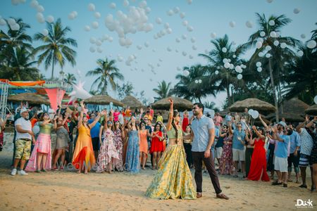 Photo of Candid shot of a couple and their squad releasing balloons.