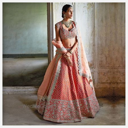 Photo of A coral lehenga with intricate details.