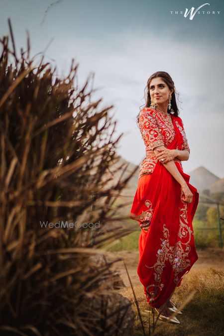 Photo of Bride dressed in a dhoti saree for her Mehendi