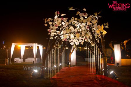 Photo of Entrance tree of life decor at night made from all white paper flowers