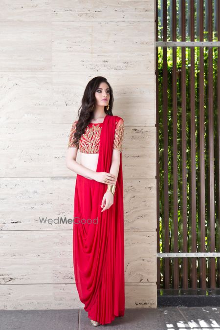 Photo of Bright red saree gown with red and gold blouse